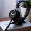 Grado Signature S150 liegt auf einem silbernen Kopfhörerverstärker auf einem Holztisch